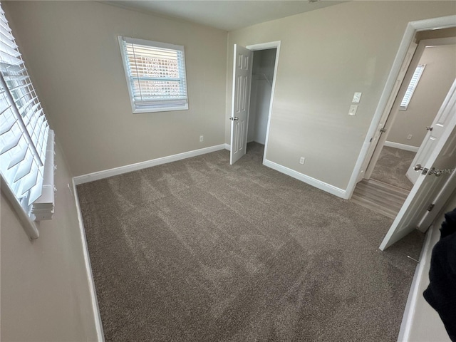 unfurnished bedroom with carpet flooring and a closet