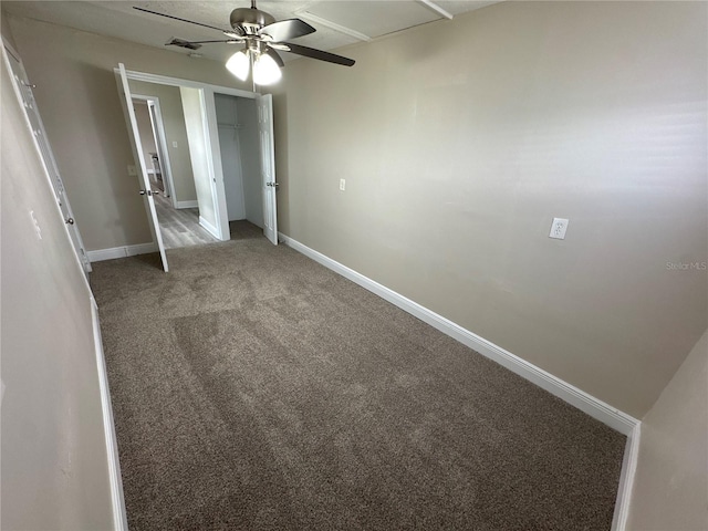 unfurnished bedroom featuring ceiling fan and carpet