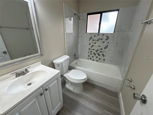 full bathroom with toilet, wood-type flooring, vanity, and tiled shower / bath combo