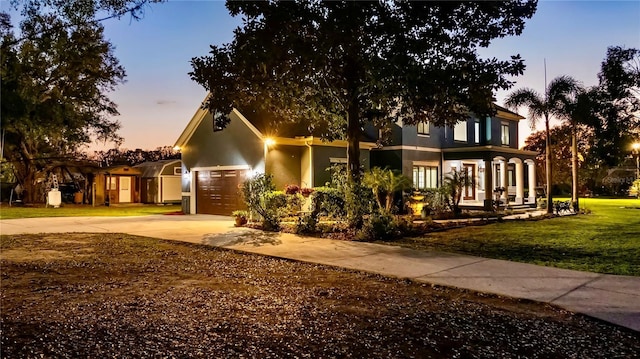 view of front of property featuring a garage and a yard