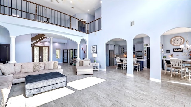 living room featuring light wood-type flooring and a notable chandelier