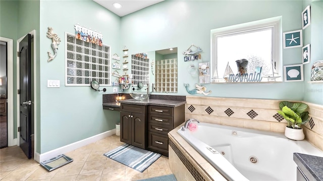 bathroom featuring vanity, tile patterned flooring, and tiled tub