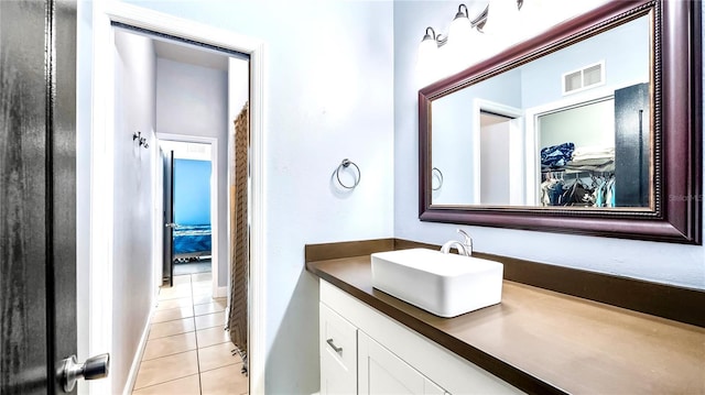 bathroom with tile patterned flooring and vanity