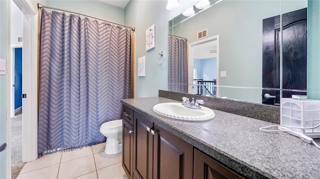 bathroom featuring vanity, toilet, and tile patterned flooring