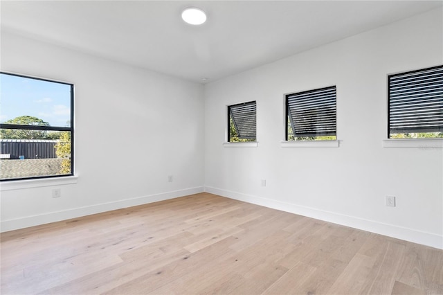 empty room featuring light wood-type flooring and a wealth of natural light