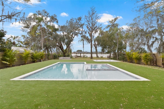 view of pool with a lawn