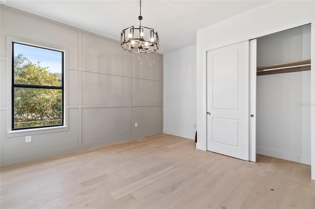 interior space featuring light hardwood / wood-style floors and an inviting chandelier