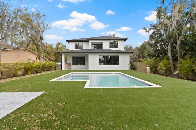 back of house featuring a lawn