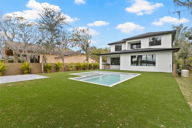 rear view of house featuring a lawn and a patio area