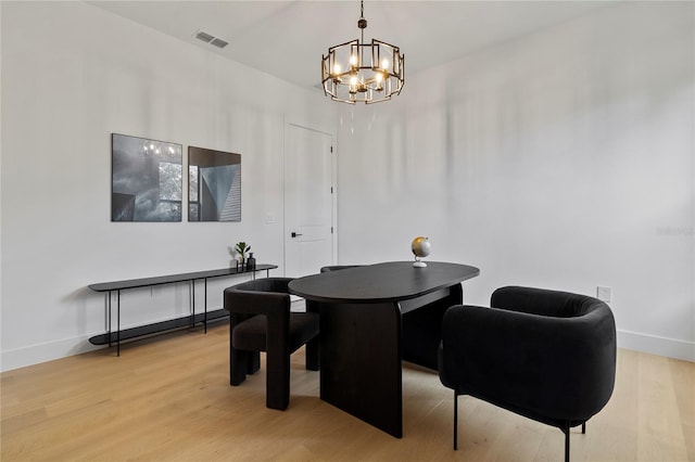 dining space with an inviting chandelier and light hardwood / wood-style floors