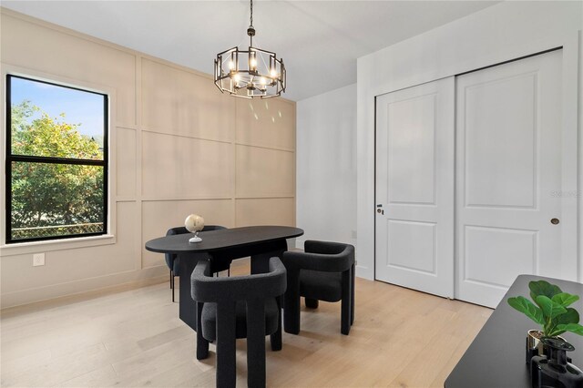 interior space with light wood-type flooring and a chandelier