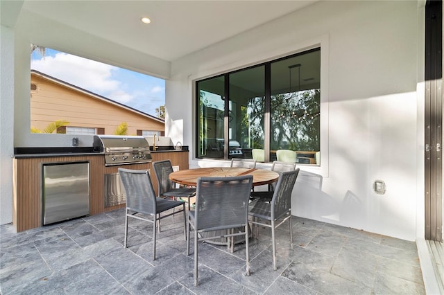 view of patio with an outdoor kitchen and a grill