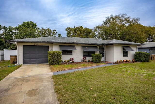 single story home with a garage and a front lawn