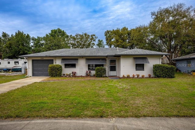 ranch-style home featuring a front lawn and a garage