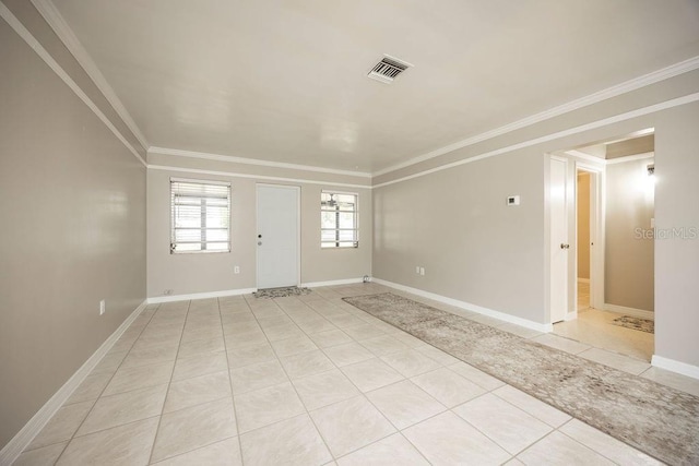 unfurnished room with crown molding and light tile patterned floors