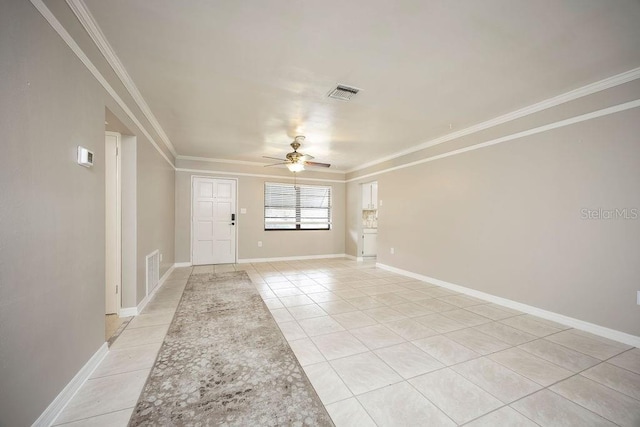 unfurnished room featuring ceiling fan, crown molding, and light tile patterned floors