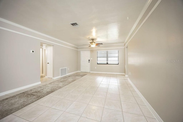 unfurnished room featuring light tile patterned floors, ceiling fan, and ornamental molding