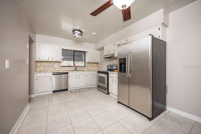 kitchen with white cabinets, sink, ceiling fan, appliances with stainless steel finishes, and light tile patterned flooring