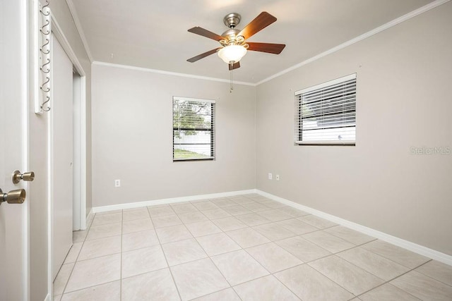 tiled spare room with ceiling fan and crown molding