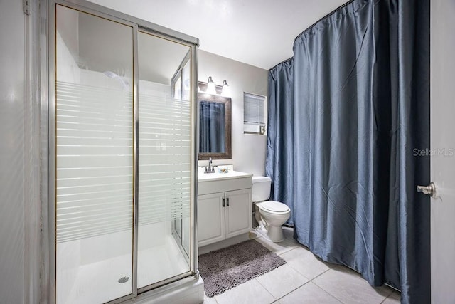 bathroom with tile patterned floors, toilet, vanity, and walk in shower