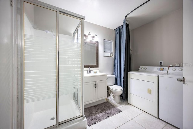 bathroom featuring walk in shower, washing machine and dryer, tile patterned floors, toilet, and vanity