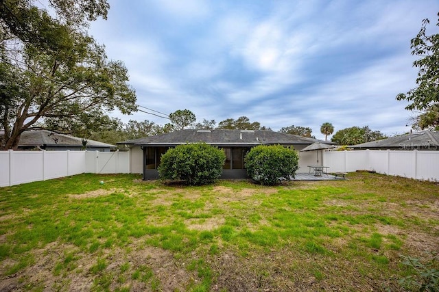 back of house featuring a lawn