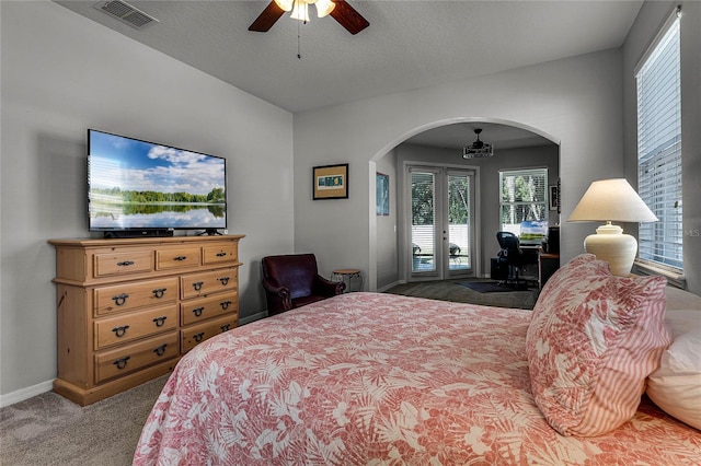 bedroom featuring ceiling fan, access to exterior, carpet, a textured ceiling, and french doors