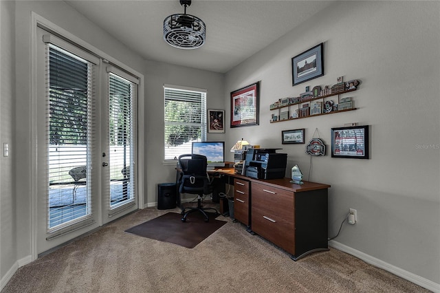 office space featuring plenty of natural light, light colored carpet, and french doors