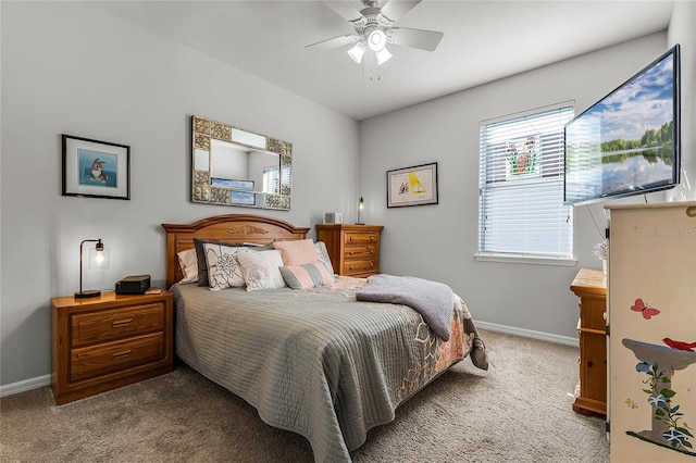 carpeted bedroom featuring multiple windows and ceiling fan