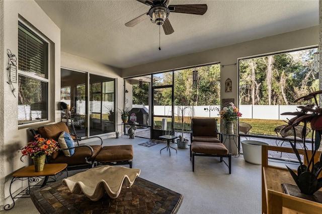 sunroom / solarium with a ceiling fan