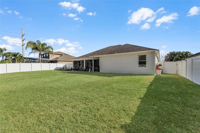 rear view of house with a yard