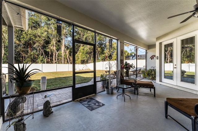 sunroom / solarium featuring ceiling fan and french doors