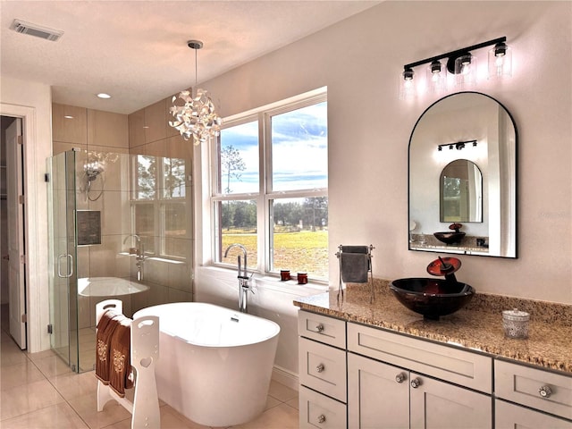 bathroom featuring a notable chandelier, tile patterned floors, separate shower and tub, and vanity