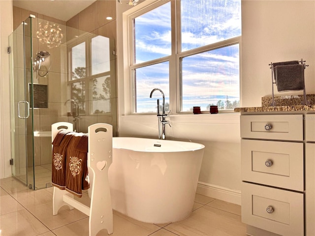 bathroom with independent shower and bath and tile patterned floors