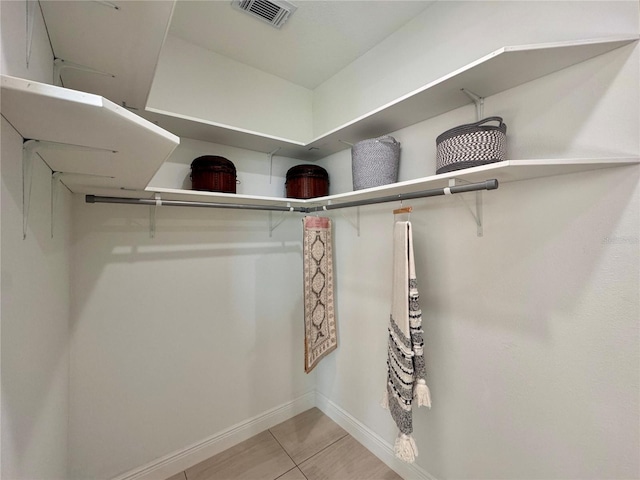 walk in closet featuring light tile patterned flooring