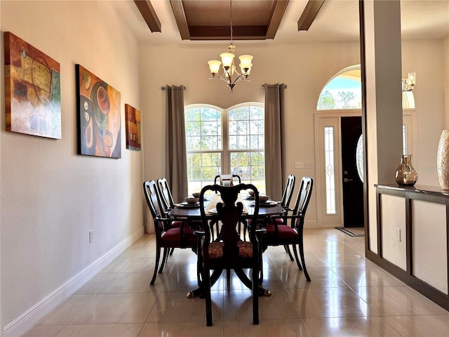 tiled dining room with a notable chandelier and a tray ceiling