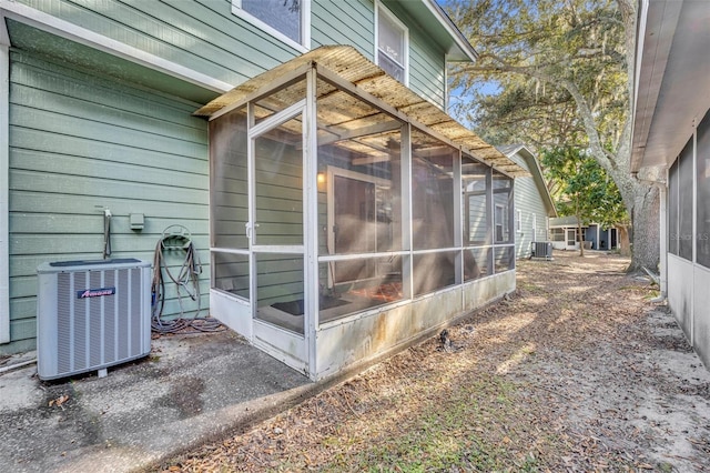 view of side of property featuring central AC unit and a sunroom