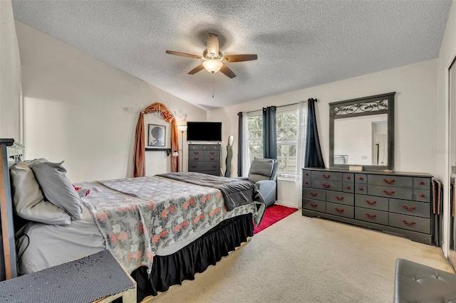 carpeted bedroom with a textured ceiling and ceiling fan