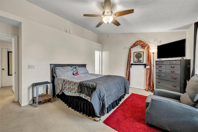 bedroom with a textured ceiling, ceiling fan, light carpet, and lofted ceiling