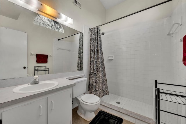 bathroom featuring a shower with shower curtain, vanity, toilet, and tile patterned flooring