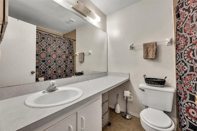 bathroom featuring tile patterned floors, vanity, and toilet