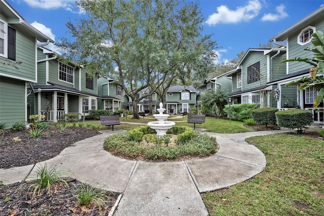 view of property's community with a yard