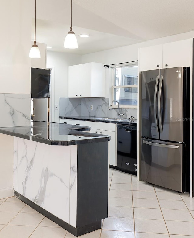 kitchen with dishwasher, white cabinetry, stainless steel refrigerator, and hanging light fixtures