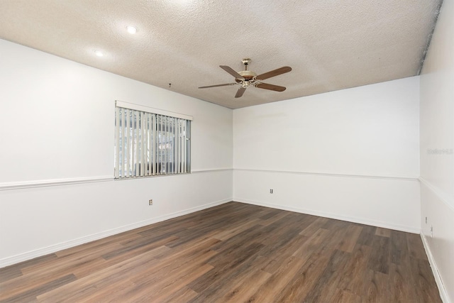 spare room featuring ceiling fan, a textured ceiling, and dark wood-type flooring