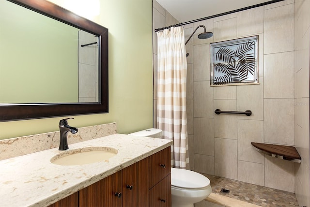 bathroom featuring a shower with curtain, vanity, and toilet