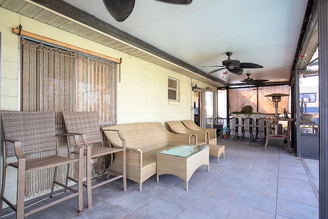 sunroom / solarium featuring ceiling fan