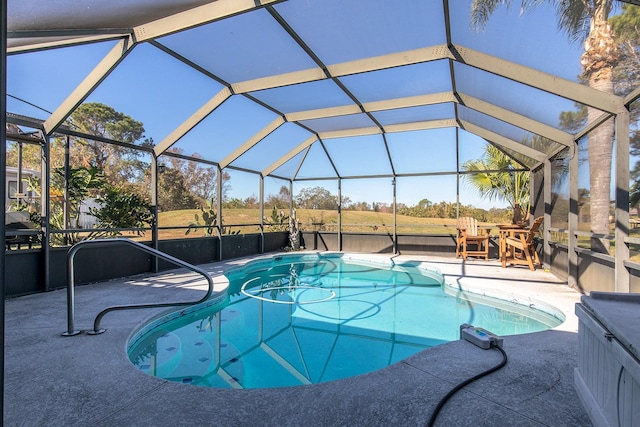 view of swimming pool featuring glass enclosure and a patio