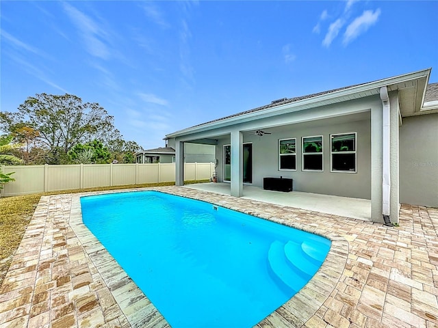 view of pool with ceiling fan and a patio