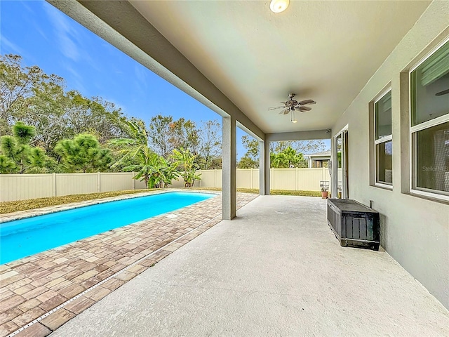 view of swimming pool with ceiling fan and a patio