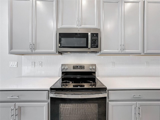 kitchen with stainless steel appliances and tasteful backsplash